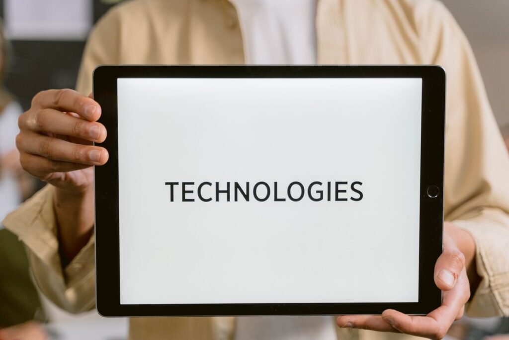 Person holding a tablet showing the word Technologies