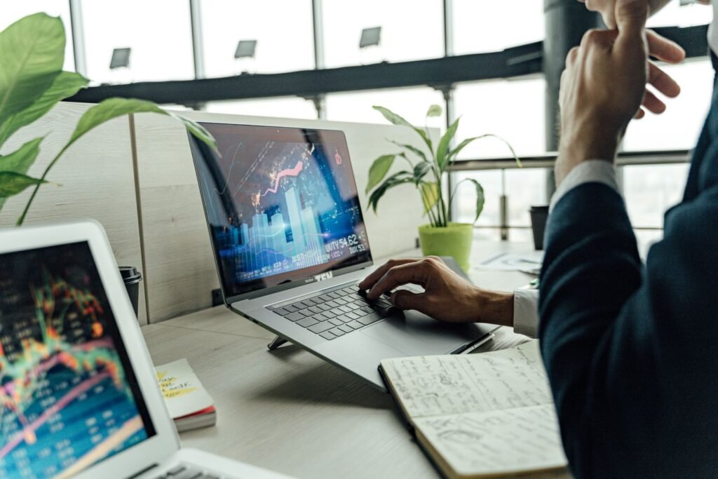 Professional reviewing data on a laptop in a bright office